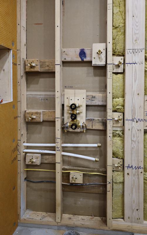New shower valves and supply lines roughed into the framed wall